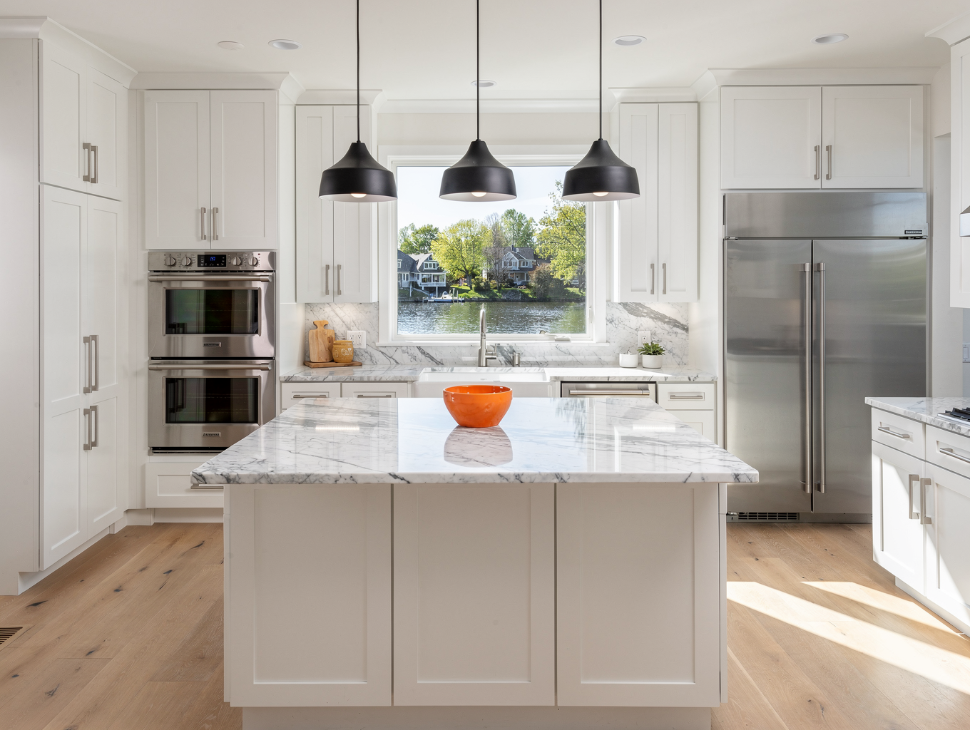 Sunlit kitchen remodel in Myers Park with brass hardware and alabaster cabinetry
